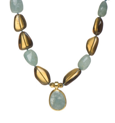 <P dir=ltr class=Body>Smooth Aquamarine and Smoky Topaz Necklace with a drop of Aquamarine wrapped with 24K Gold 20" Long or upon request Aquamarine drop may vary in shape and size</P>