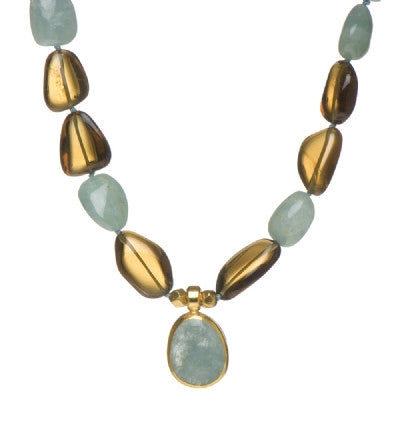 <P dir=ltr class=Body>Smooth Aquamarine and Smoky Topaz Necklace with a drop of Aquamarine wrapped with 24K Gold 20" Long or upon request Aquamarine drop may vary in shape and size</P>