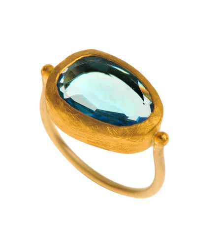 <P dir=ltr class=Body>Uneven shaped Blue Topaz Gold ring wrapped with 24K Gold Available any size! Shape and size of Stone may vary</P>