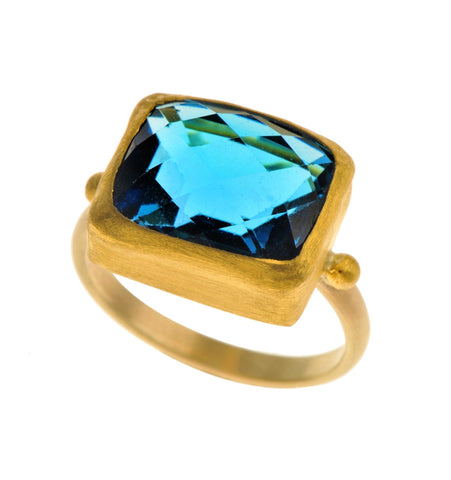 <P dir=ltr class=Body>Rectangle Blue Topaz Ring wrapped with 24K Gold on Gold Band </P>