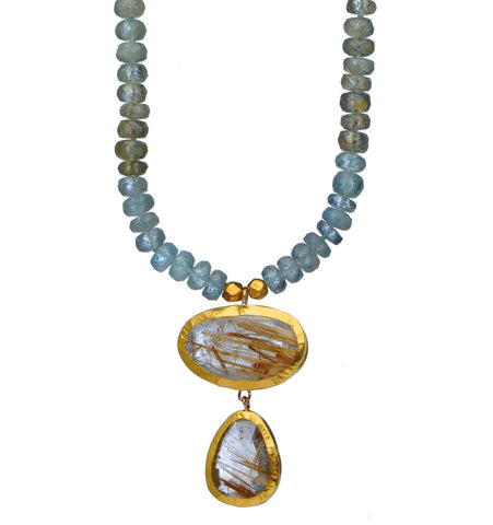 <P dir=ltr class=Body>Aquamarine necklace with 2 drops of Ruthilated Quartz wrapped in 24K Gold 18" Long or upon request Ruthilated Quartz Drops Hang 37mm Width 25mm Shape, size and Color of Drops may vary!</P>