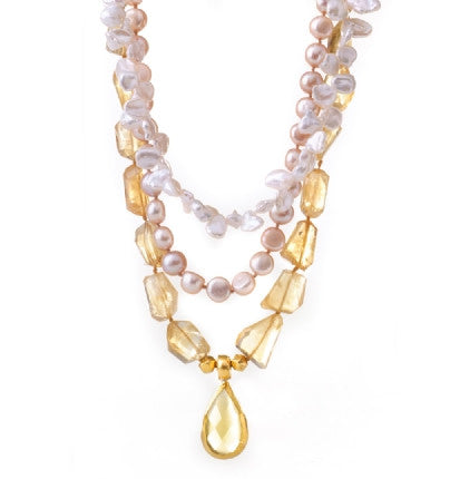 This amazingly beautiful three-stranded Necklace is finely hand-crafted of dazzling Citrine nuggets and luminescent Pearls. It has a gorgeous pear-shaped Citrine drop wrapped in 24K Gold. It is feminine and elegant, and will be a treasure for a lifetime. Length 16.5"&nbsp;to 23"